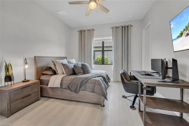 a bedroom with a bed and a desk