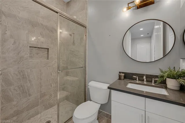 a bathroom with a sink a toilet and a mirror