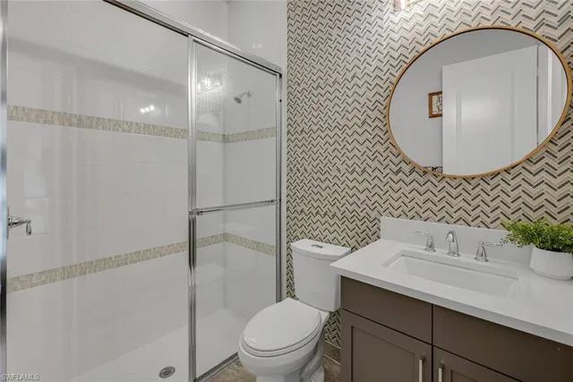 a bathroom with a sink toilet and mirror