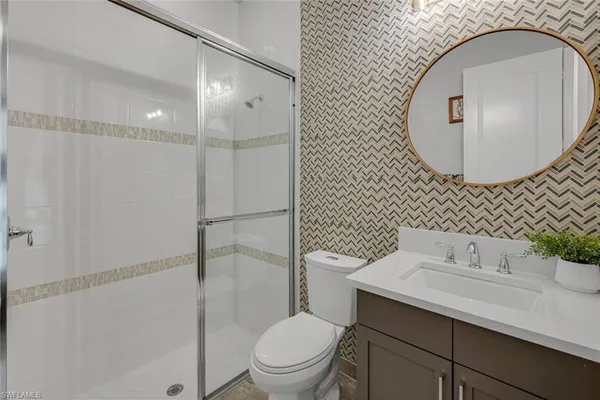 a bathroom with a sink toilet and mirror