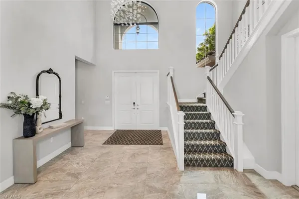 a view of a bedroom with wooden floor and windows