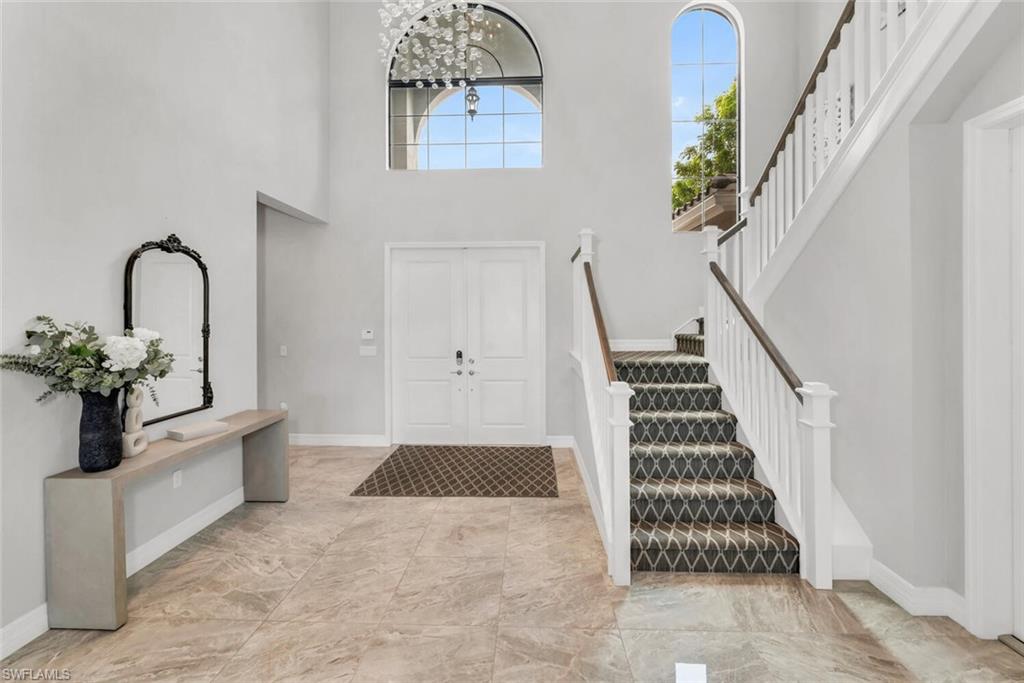 4541 Azalea Drive Naples, FL 34119 - Photo 18 of 35 Tiled foyer featuring a towering ceiling and a chandelier
