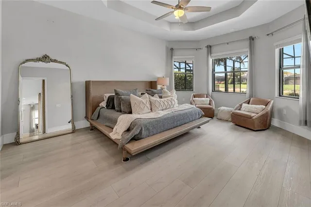 a spacious bedroom with a bed a couch and dresser