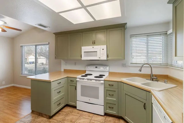 a kitchen with a sink stove and cabinets
