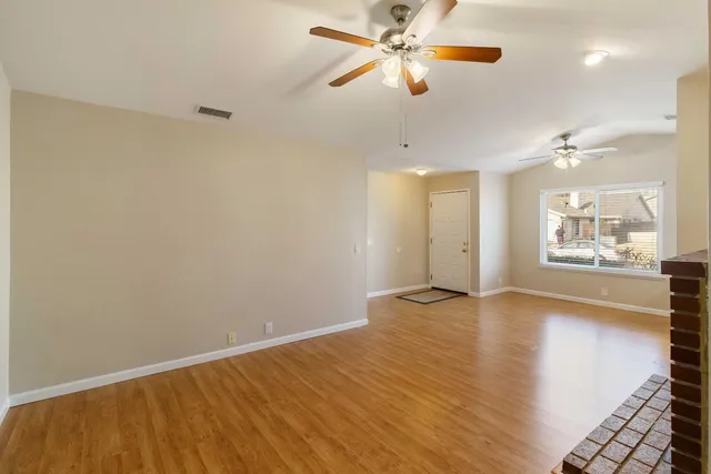 wooden floor in an empty room with a window