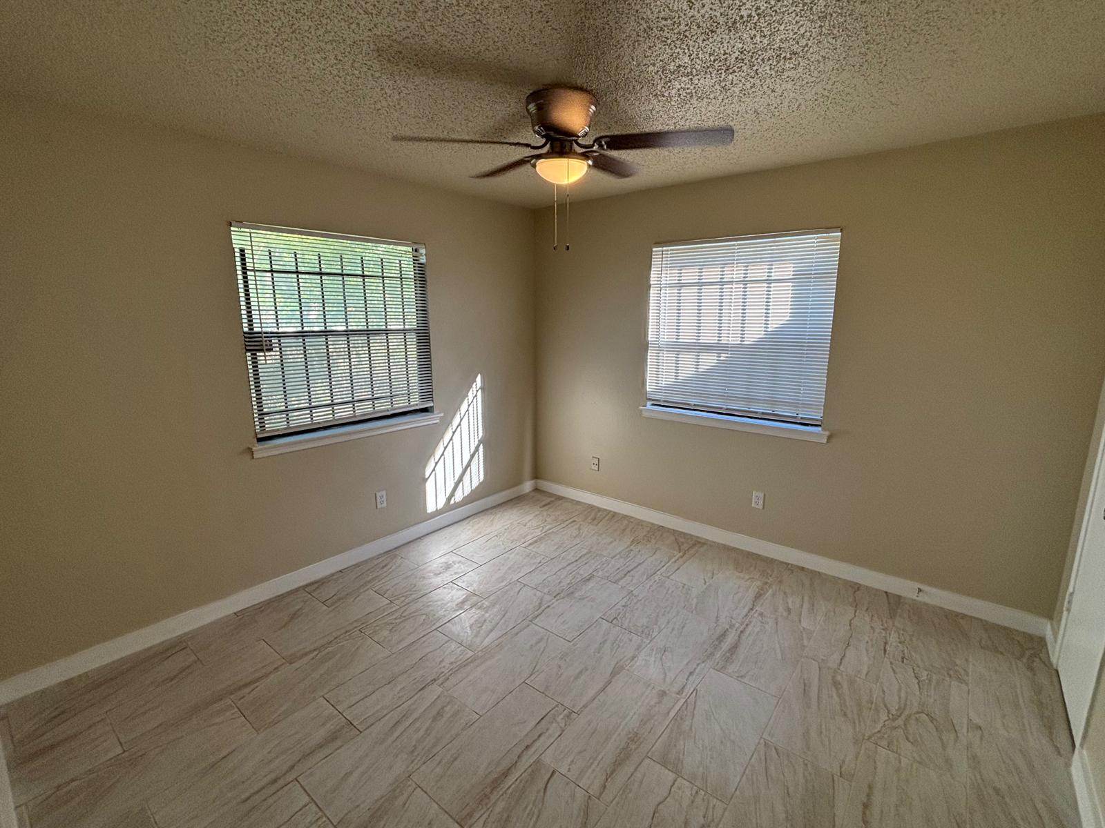 4609 East 12th Street, Unit 4 Austin, TX 78721 - Photo 11 of 14 Natural light pours across the wood-look tile flooring through two well-placed windows.