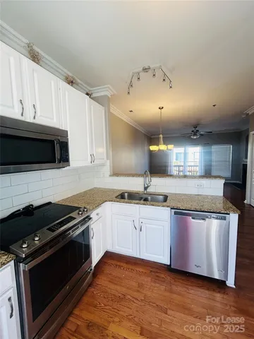 a kitchen with stainless steel appliances granite countertop a stove and a microwave