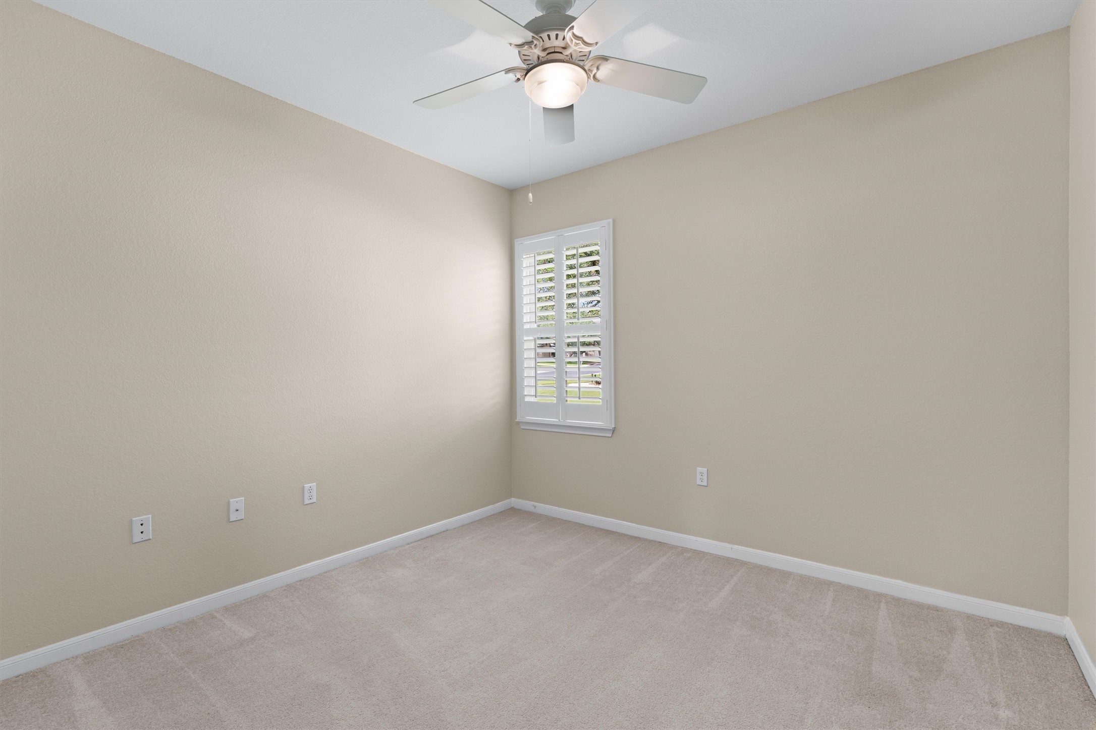 321 Yukon Terrace Georgetown, TX 78633 - Photo 9 of 15 an empty room with a chandelier fan and windows