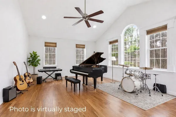 a living room with furniture pool table and a large window