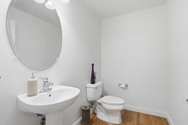 a bathroom with a sink a mirror and a toilet