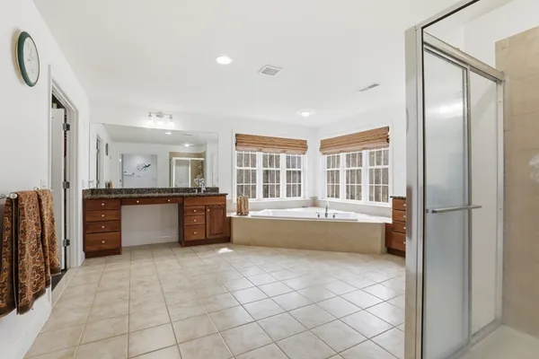 a large white kitchen with a large window and counter space