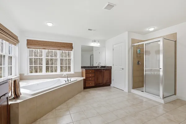 a large spacious bathroom with a large tub shower and sink