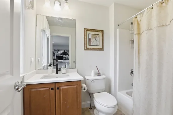 a bathroom with a sink vanity mirror and toilet