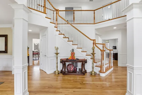 a view of entryway and hall with wooden floor
