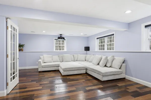 a living room with furniture and a wooden floor