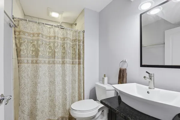 a bathroom with a sink toilet and shower