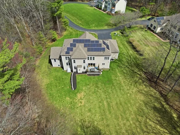 an aerial view of a house with pool yard and outdoor seating