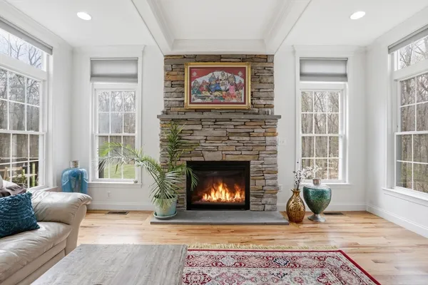 a living room with furniture a fireplace and windows