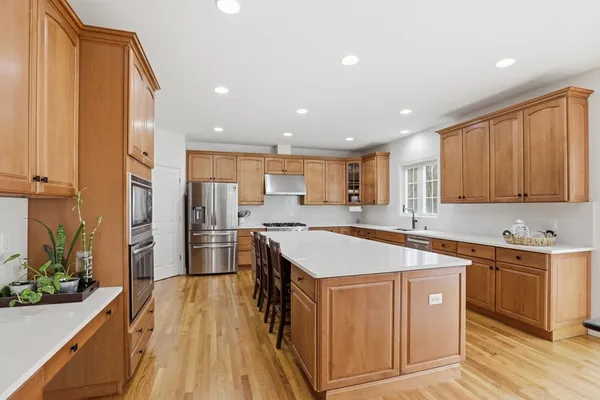 a kitchen with a sink stove and wooden cabinets
