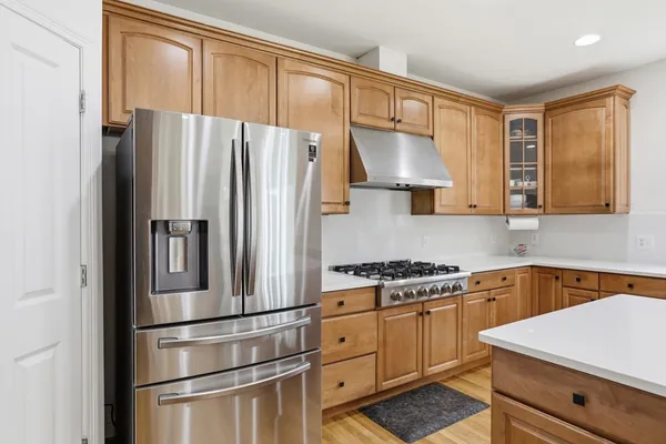 a kitchen with stainless steel appliances a refrigerator sink and cabinets
