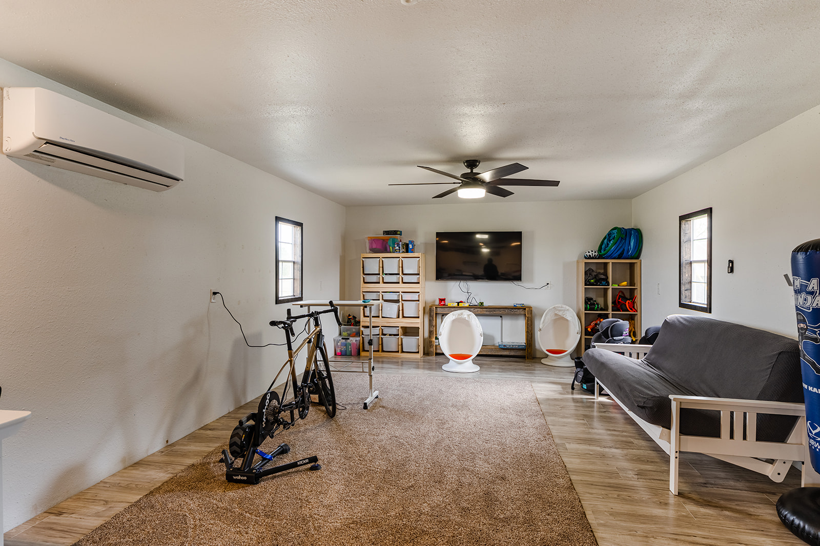 1001 Gravel Pit Road Taylor, TX 76574 - Photo 31 of 38 Workout room featuring light wood finished floors, ceiling fan, and a textured ceiling