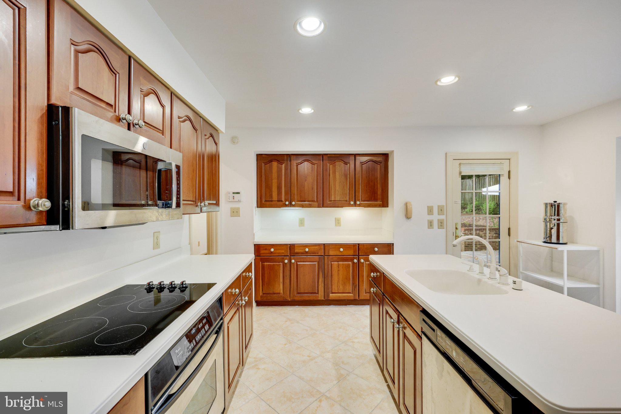 1427 Laurel Hill Road Vienna, VA 22182 - Photo 20 of 57 Modern kitchen with rich cabinetry.