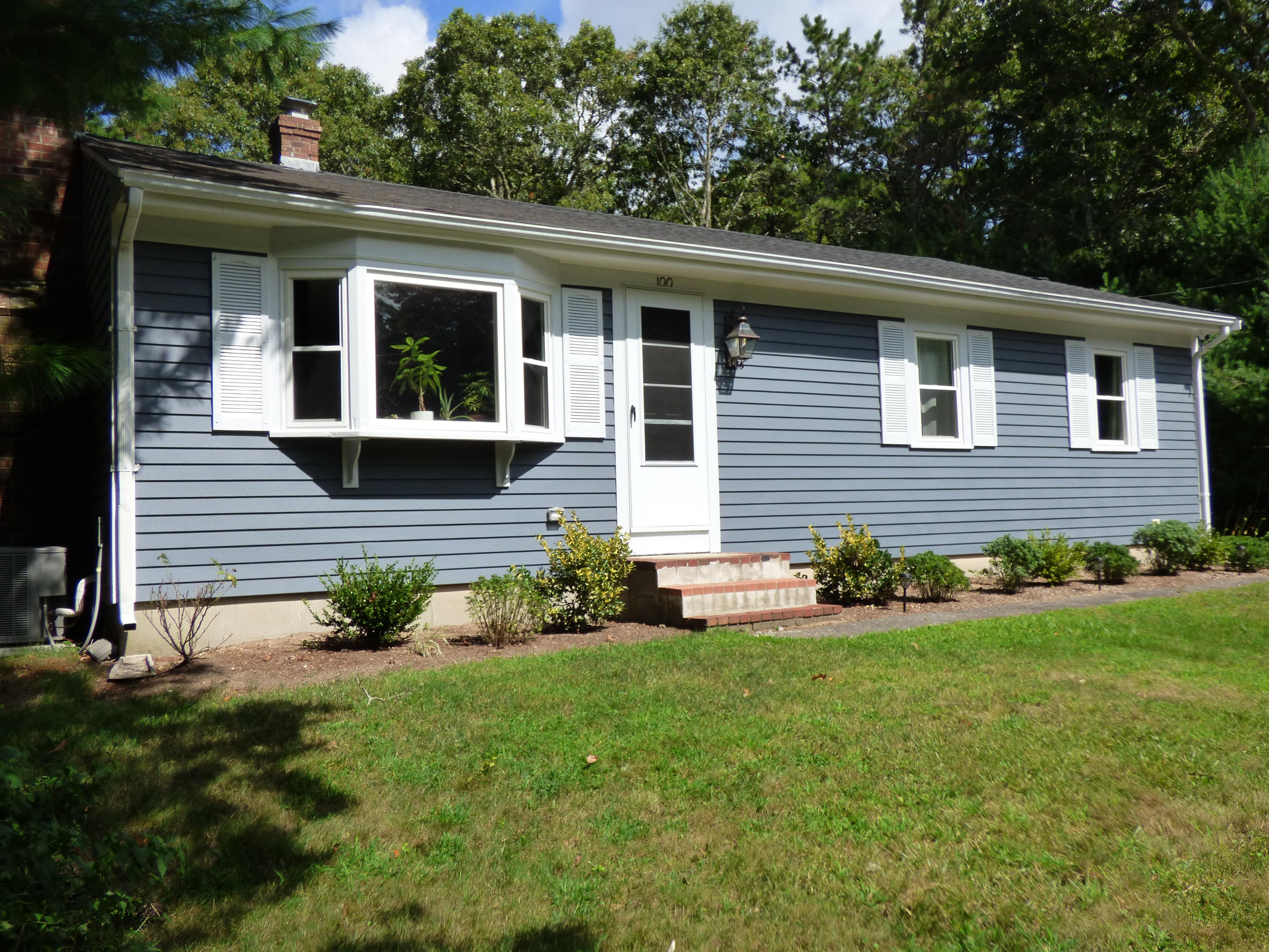 a view of house that has a yard