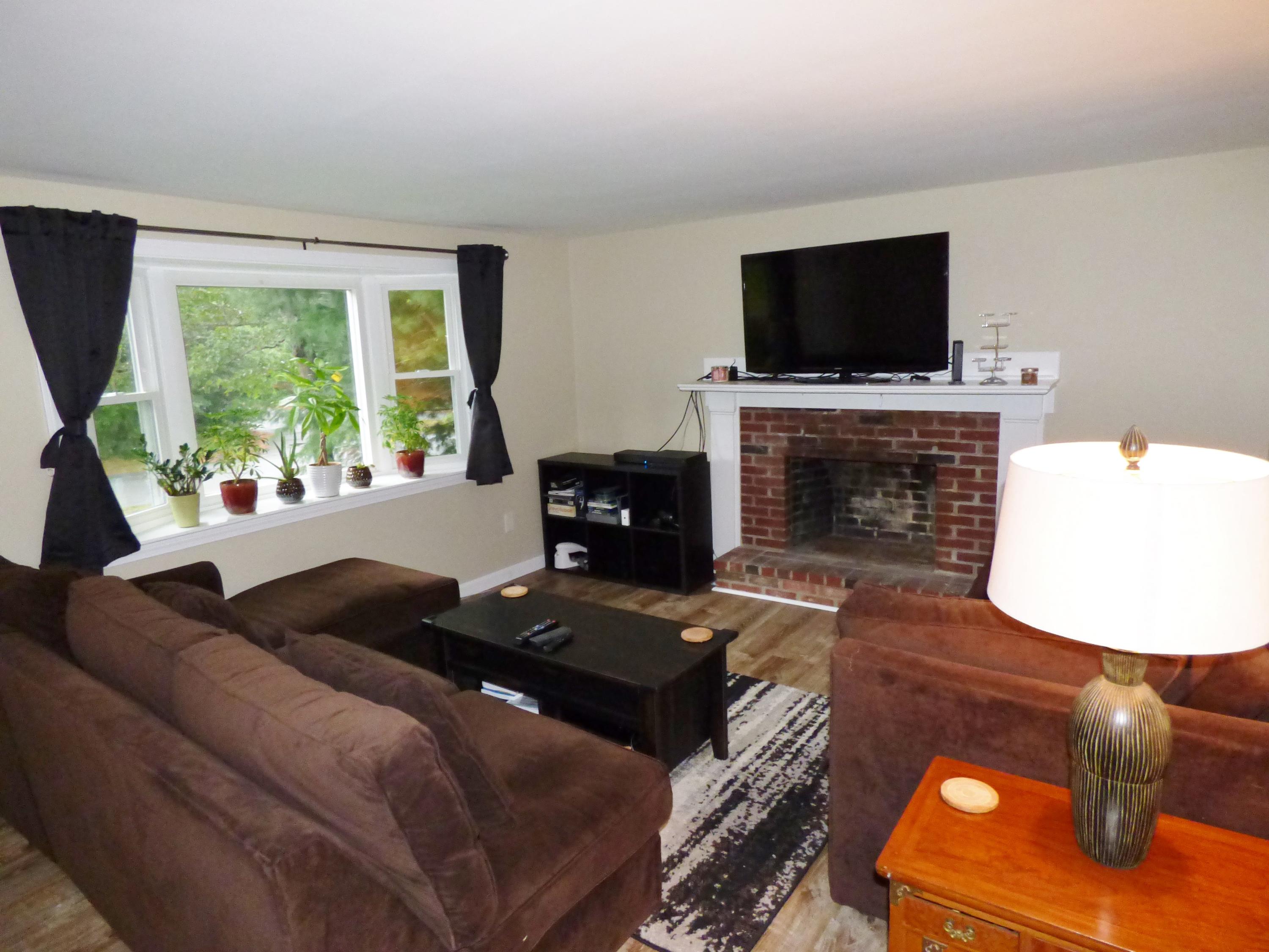 100 Taramac Road Centerville, MA 02632 - Photo 2 of 18 a living room with furniture and a fireplace