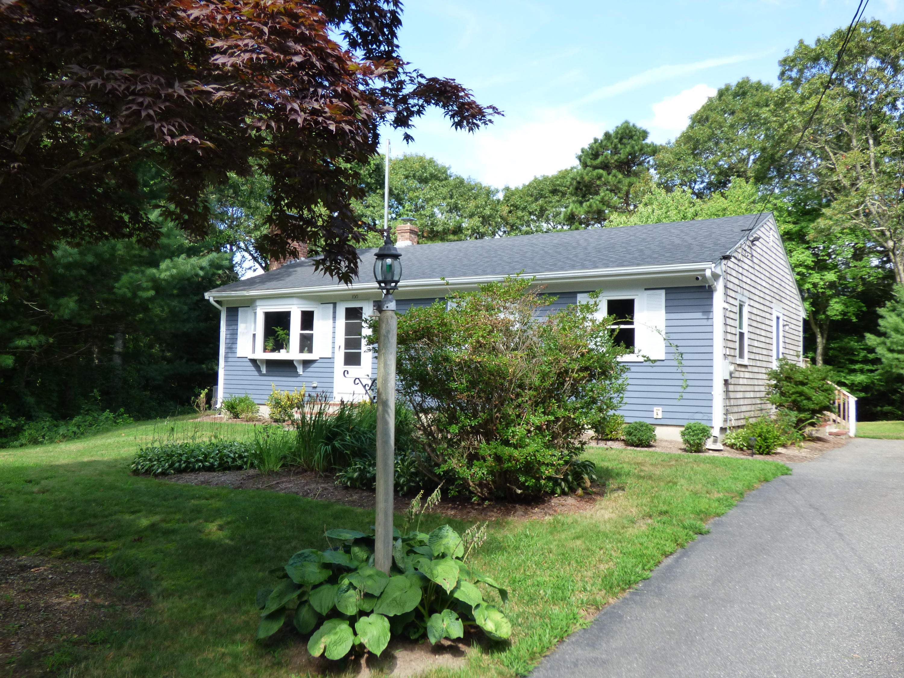 100 Taramac Road Centerville, MA 02632 - Photo 8 of 18 a front view of a house with garden