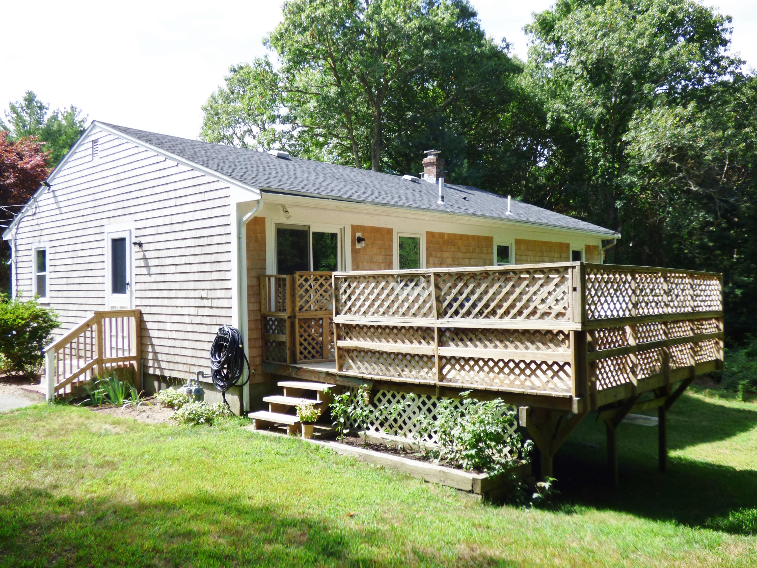 100 Taramac Road Centerville, MA 02632 - Photo 9 of 18 a front view of a house with a yard