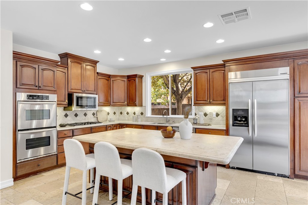 2105 Canyon Circle Costa Mesa, CA 92627 - Photo 13 of 35 a kitchen with granite countertop a refrigerator and a stove top oven