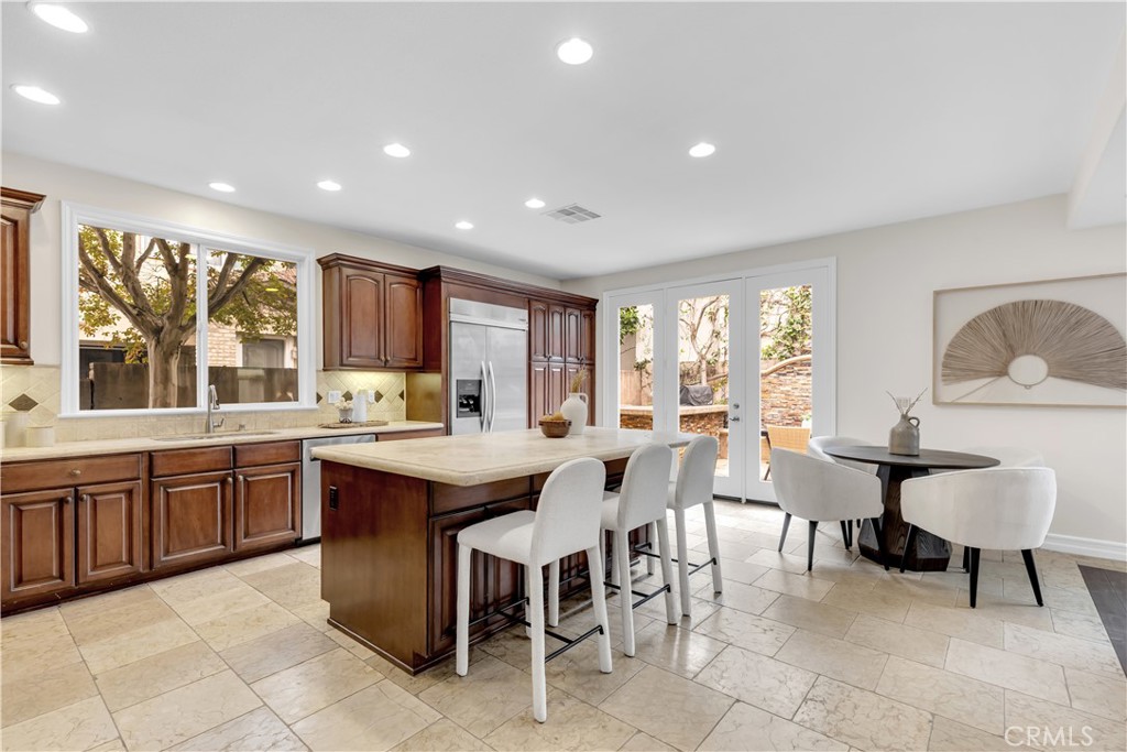 2105 Canyon Circle Costa Mesa, CA 92627 - Photo 14 of 35 a large kitchen with lots of furniture a sink and dining table chair