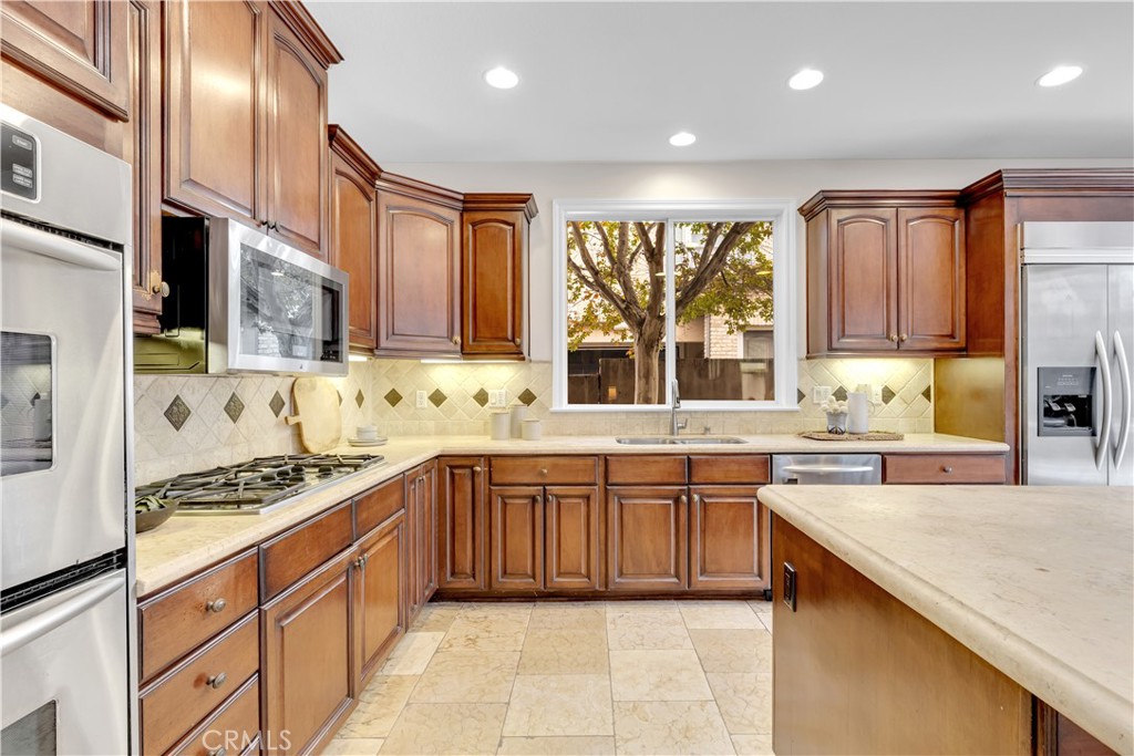 2105 Canyon Circle Costa Mesa, CA 92627 - Photo 16 of 35 a kitchen with stainless steel appliances granite countertop a sink and cabinets