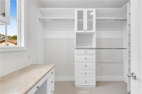 a en suite bathroom with a granite countertop sink and a mirror