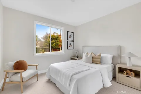 a spacious bedroom with a bed and a large window