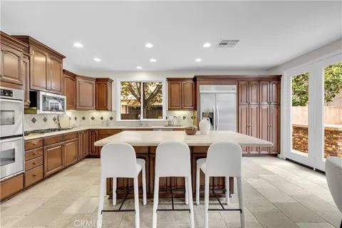 a large kitchen with a table and chairs