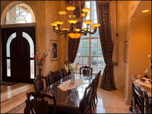 a view of a dining room with furniture and chandelier