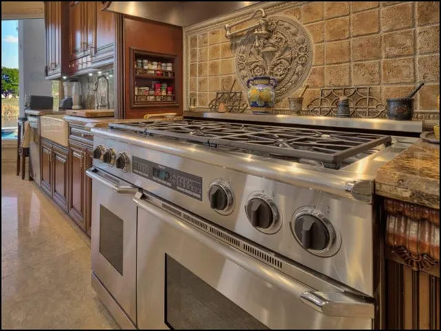 a kitchen with a stove a microwave and wooden floor
