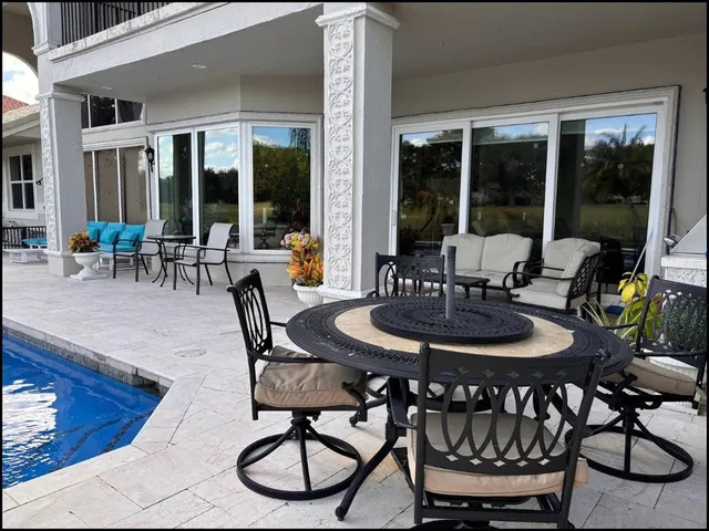 a living room with furniture a clock and a painting on the wall