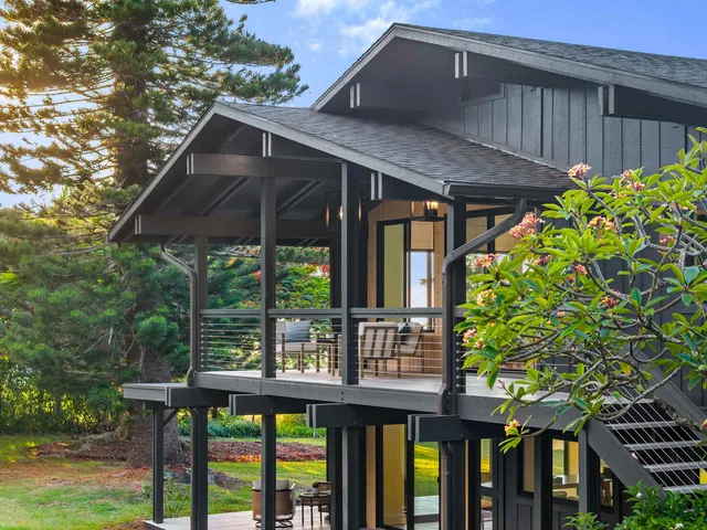 a view of a wooden house with a yard