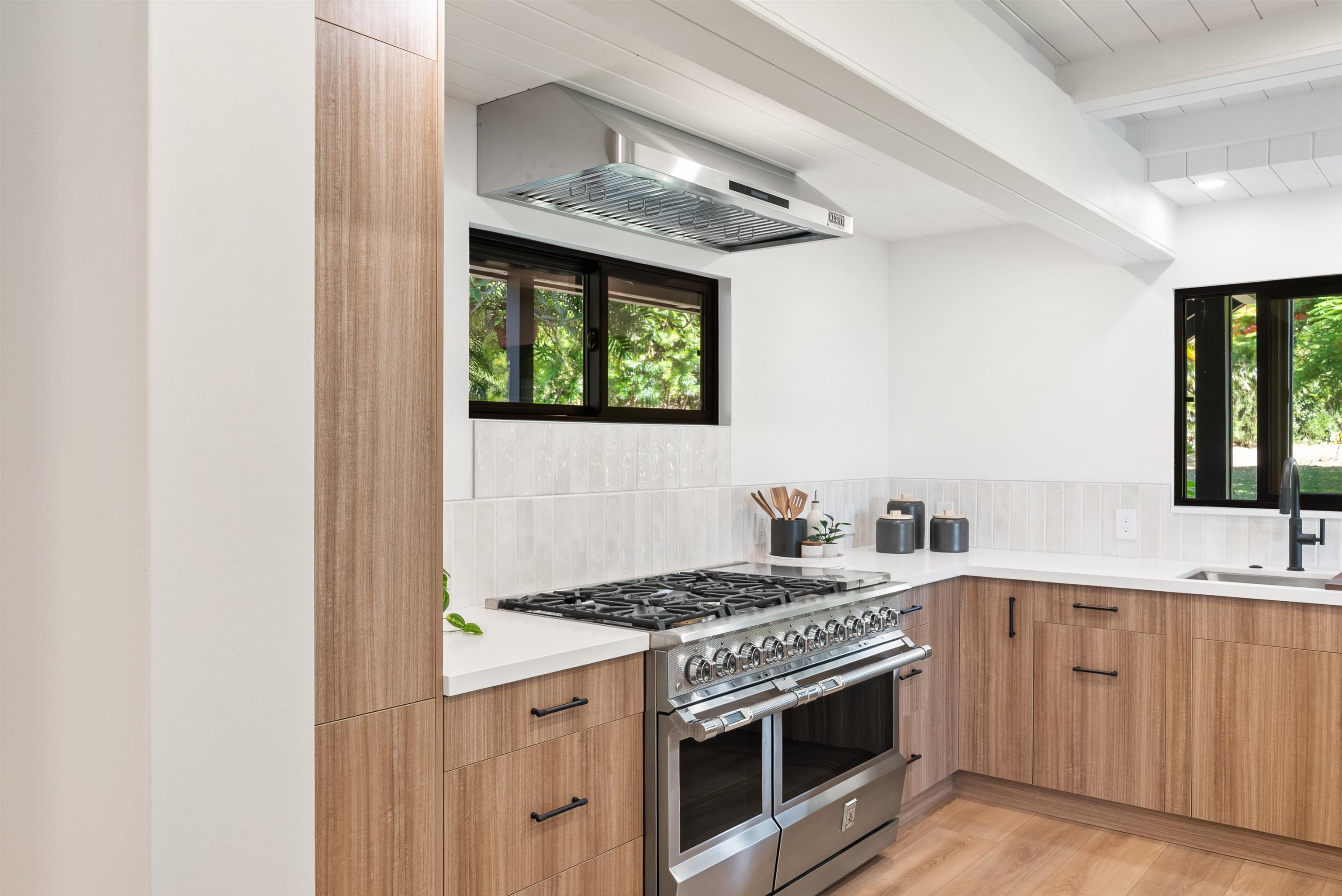 965 Hog Back Road Haiku, HI 96708 - Photo 7 of 35 a kitchen with stainless steel appliances granite countertop a stove and a sink
