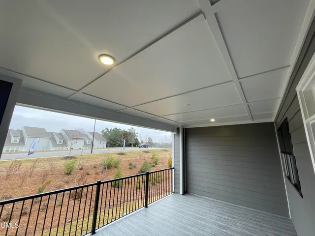 a view of a hallway with stairs and wooden floor