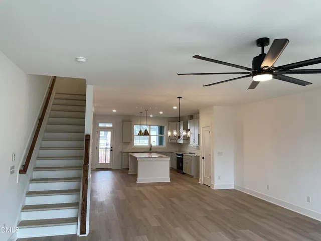 a view of a kitchen with wooden floor and electronic appliances