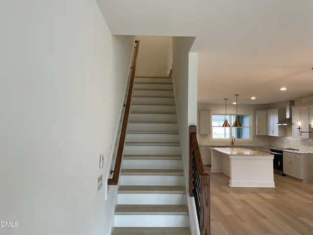 a view of kitchen with wooden floor and electronic appliances