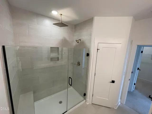 a bathroom with a shower a toilet and sink