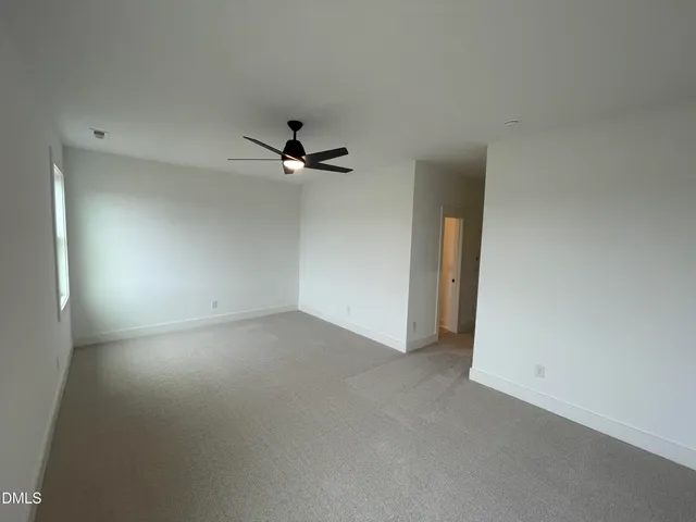a view of a room with a ceiling fan