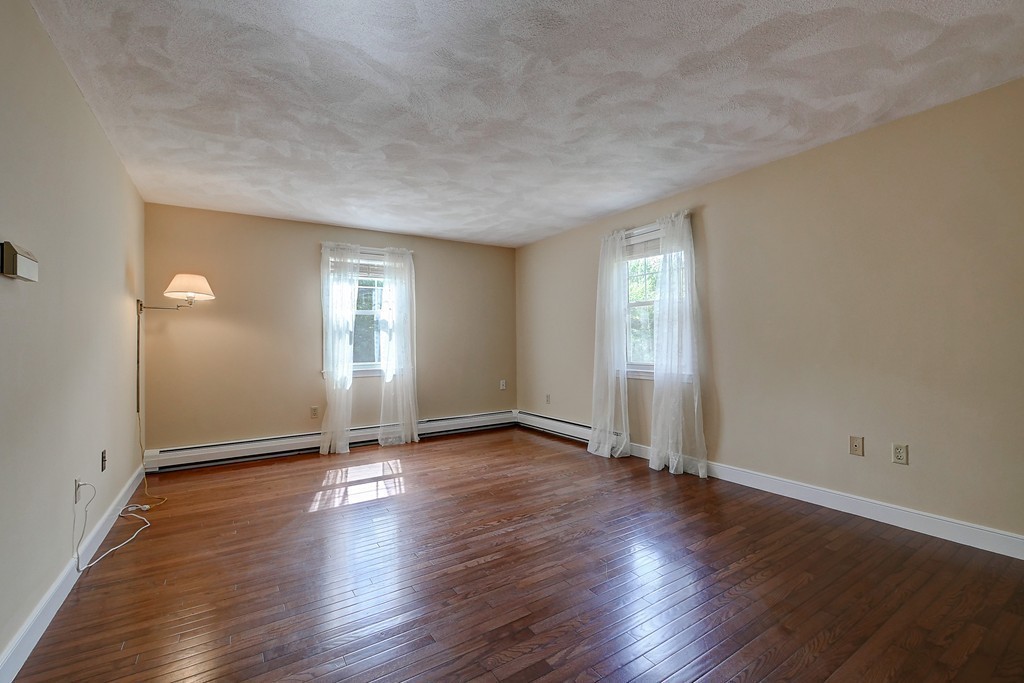 32 Bayberry Road Groton, MA 01450 - Photo 13 of 30 an empty room with wooden floor and windows