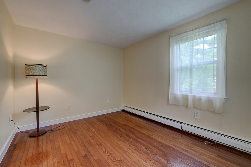 32 Bayberry Road Groton, MA 01450 - Photo 18 of 30 a room with a wooden floor and a window