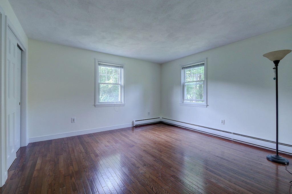 32 Bayberry Road Groton, MA 01450 - Photo 20 of 30 an empty room with wooden floor and windows