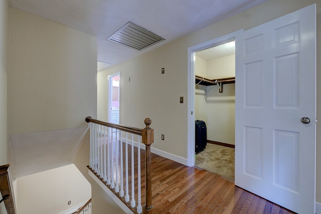 32 Bayberry Road Groton, MA 01450 - Photo 21 of 30 a view of a hallway with wooden floor and staircase